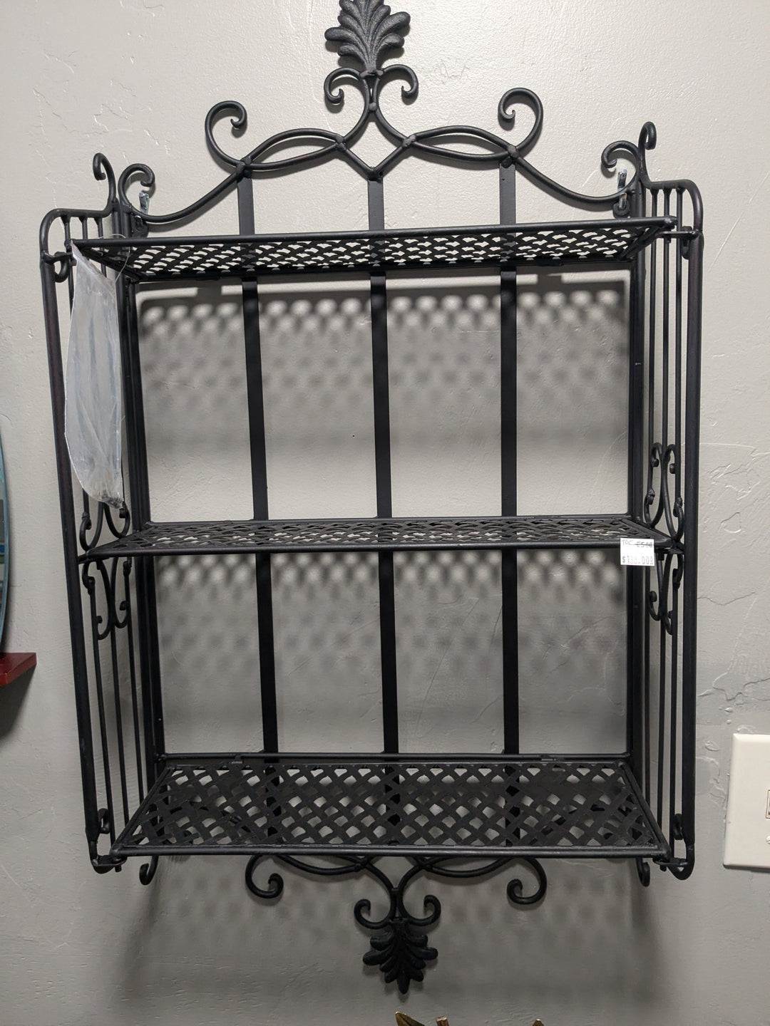 Black Metal 3-Tiered Wall Shelf – a stylish and modern shelving unit featuring three tiers of sturdy metal, perfect for displaying plants, books, and decorative items. Ideal for enhancing home decor while maximizing vertical space in any room
